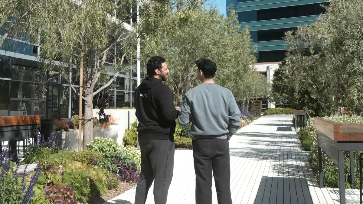 Adil and his team near their campus.