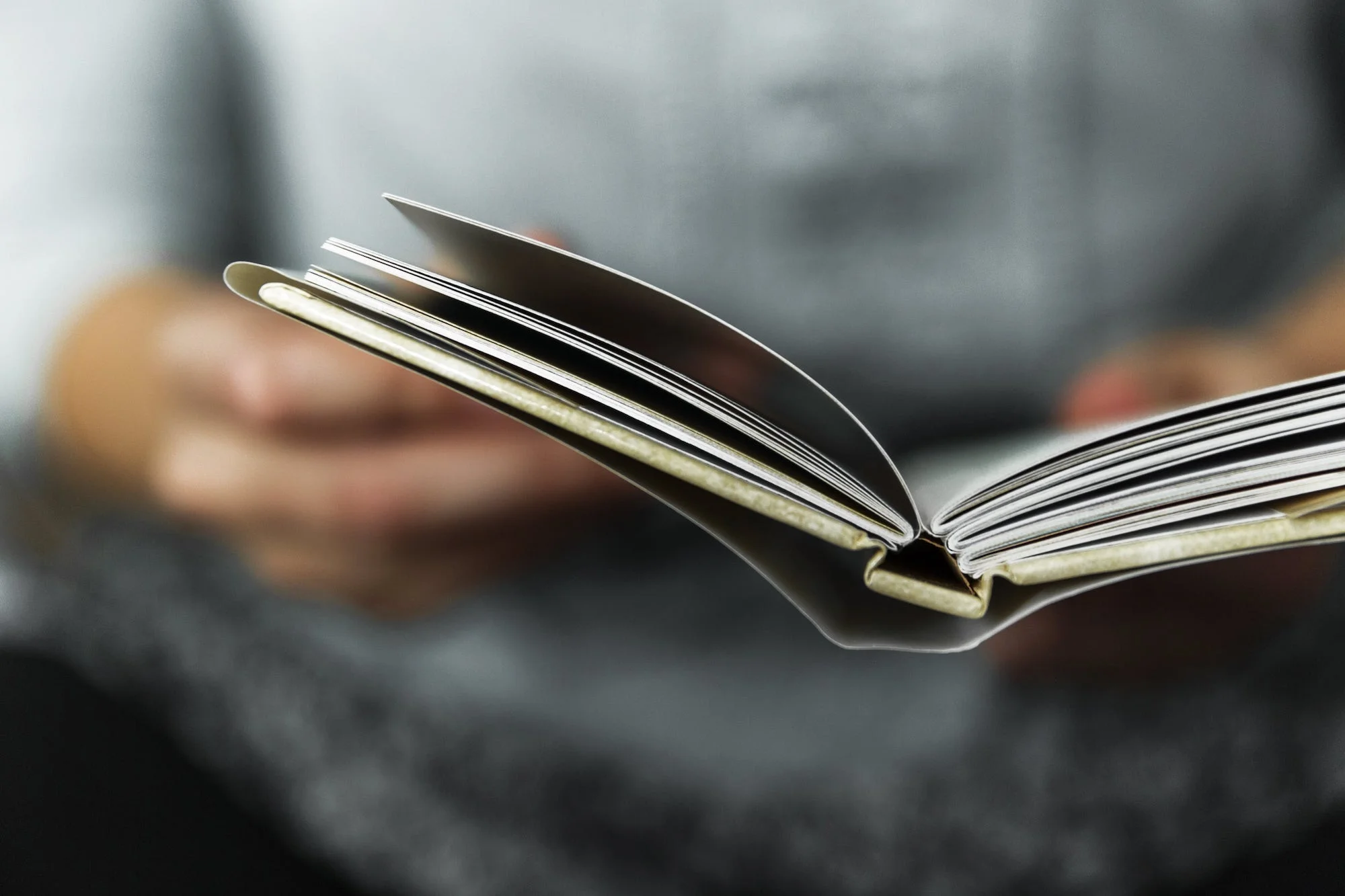 Person holding a book.